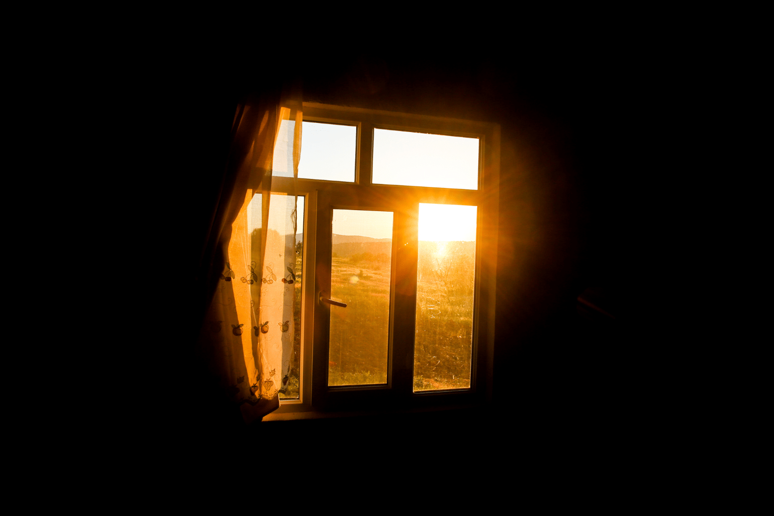 Morning streaming in the window in a dark room