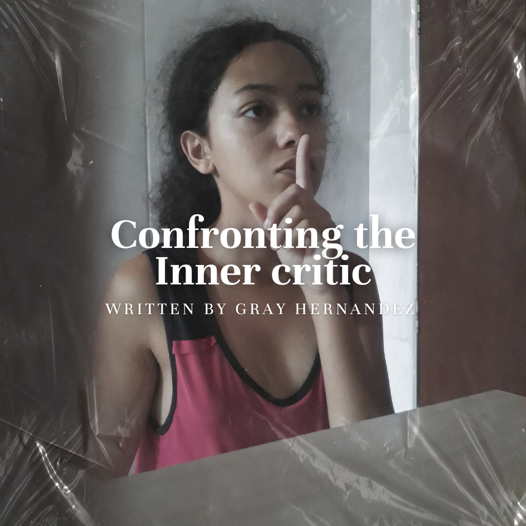 Girl looking in mirror with her finger to her mouth, silencing herself