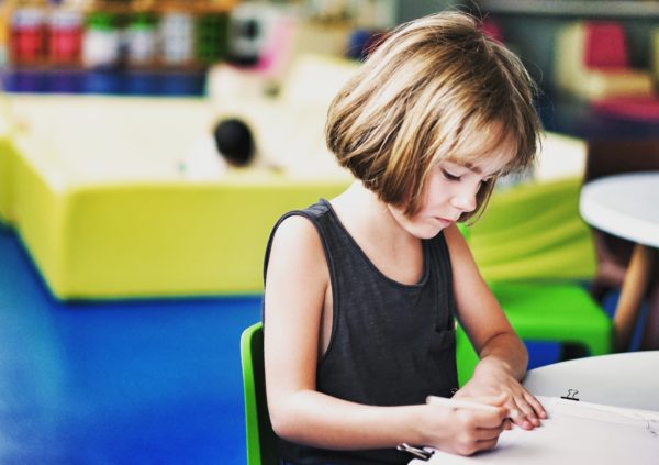 child coloring at table