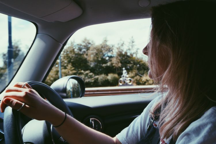 close up side profile of woman driving a car