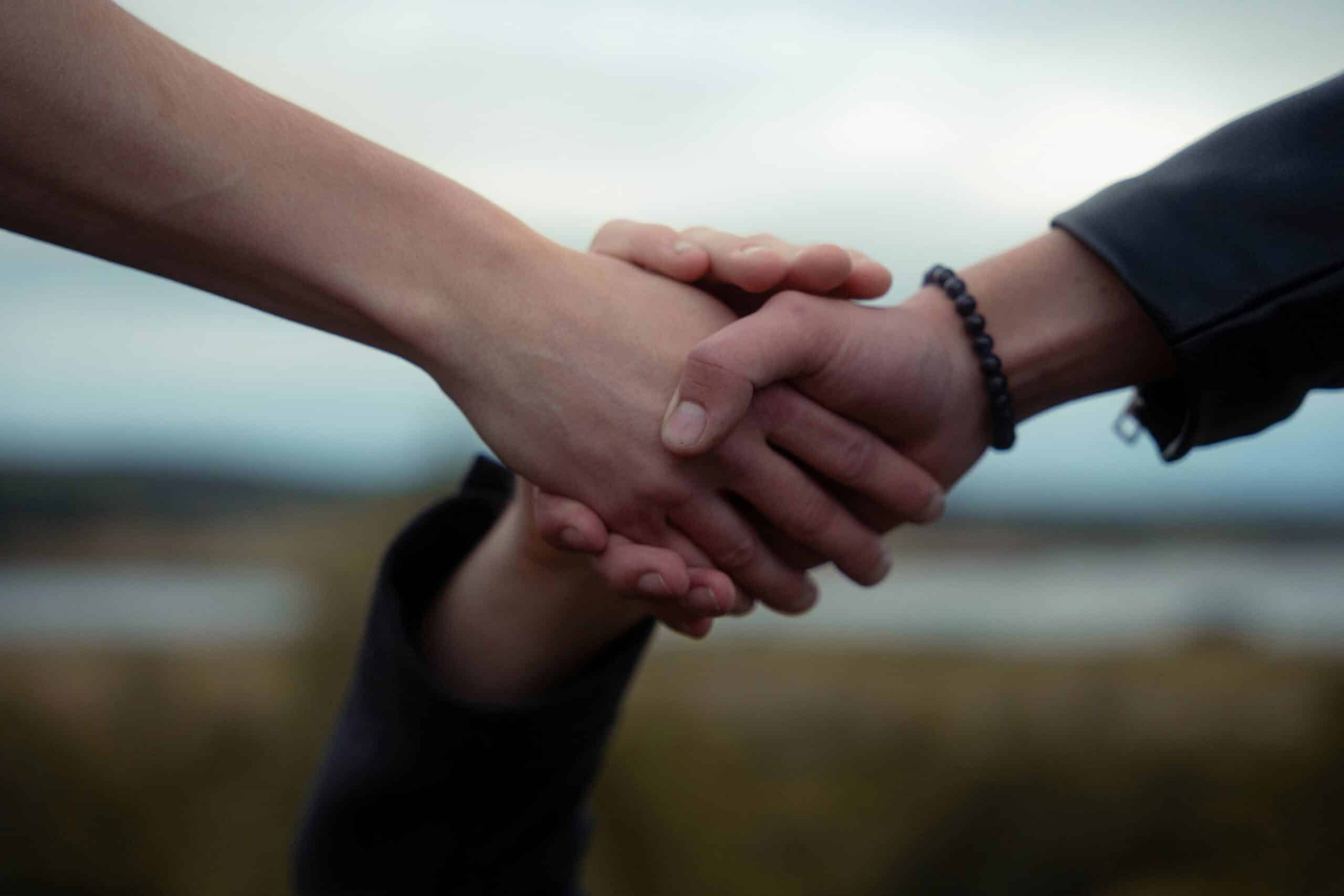 three people holding hands