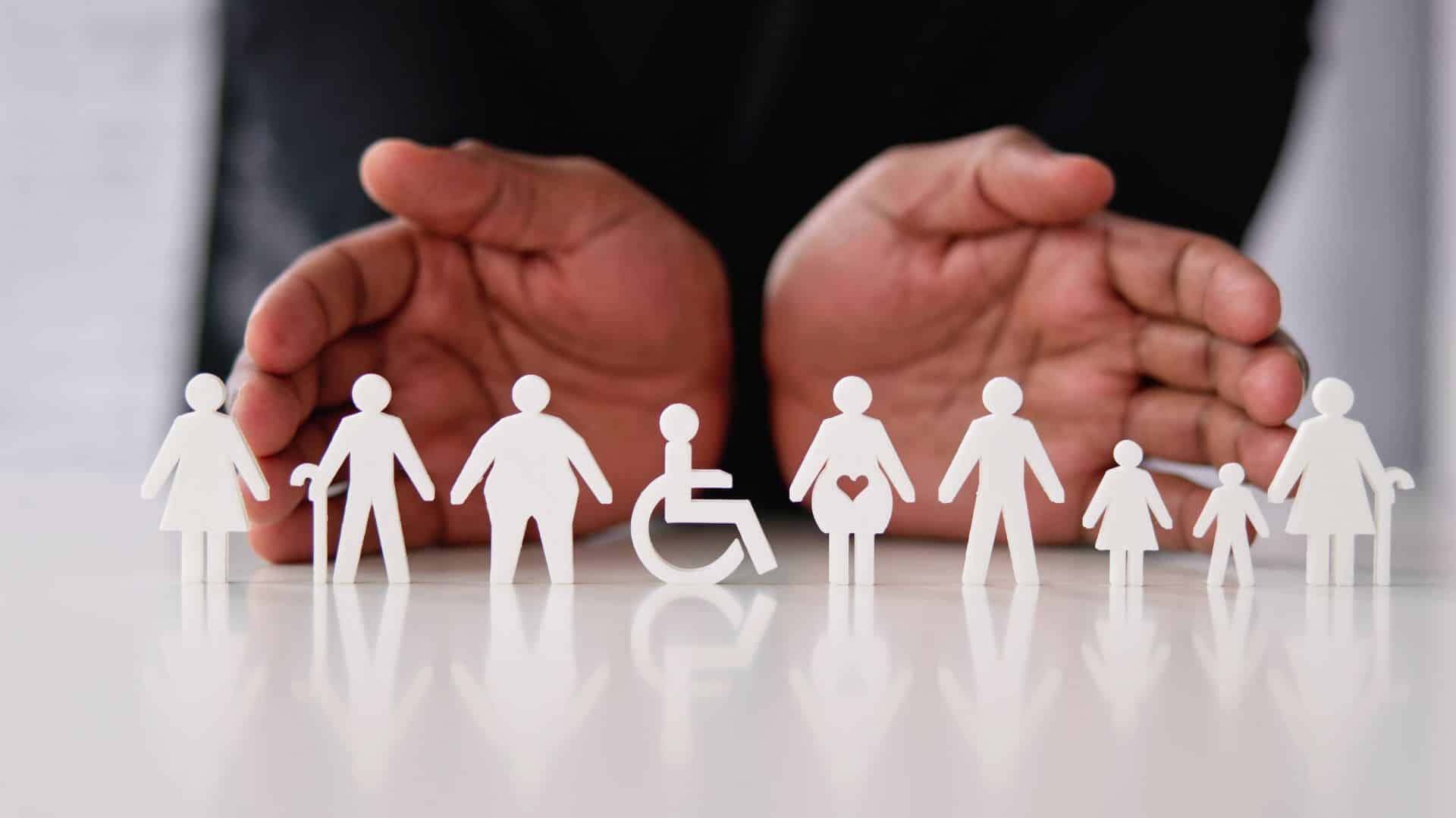 a diverse collection of paper cutouts including a wheelchair-bound person